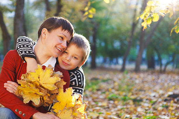 istock Mother and her son in a autumn park 594012324