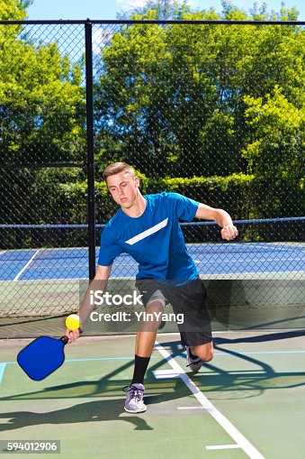 istock Young Man Pickleball Player Playing Pickleball in Court 594012906