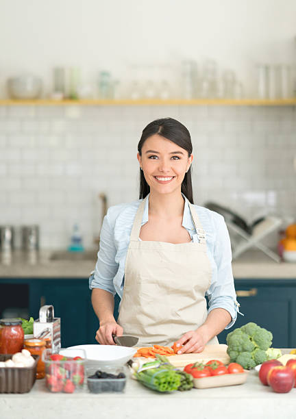 istock Happy Latin woman cooking at home 594013268