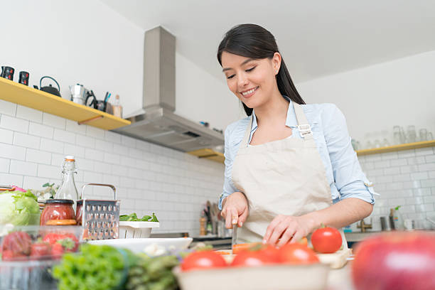 istock Happy woman cooking at home 594013274