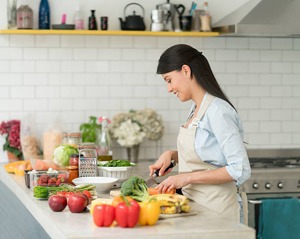istock Latin woman cooking at home 594013302