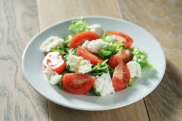 istock fresh summer salad with tomatoes, rucola, frillis and mozzarella 594014302