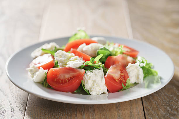 istock summer light salad with tomatoes, mozzarella and rocket leaves 594014350