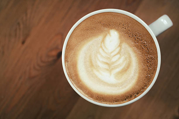 istock cup of cappuccino on wood table with latte art 594014778