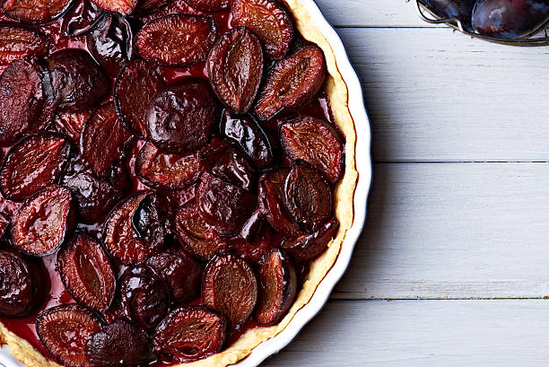 istock Homemade pie with plums on the table 594015326
