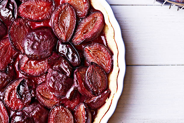 istock Homemade pie with plums on the table 594015436