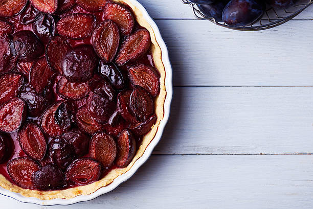 istock Homemade pie with plums on the table 594015528