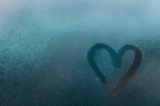 istock Heart shape on glass with water drops 594015556