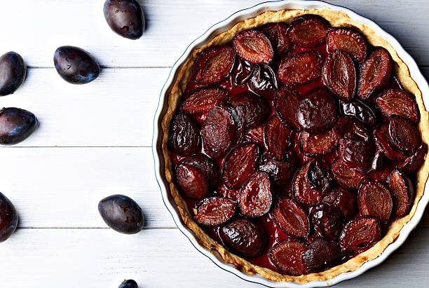 istock Homemade pie with plums on the table 594015716