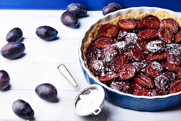 istock Homemade pie with plums and sieve on the table 594015982