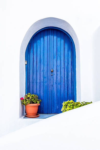 istock white wall with blue wooden door 594016356
