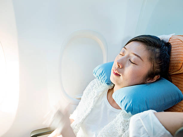 istock Young asian woman sleeping on airplane 594016670