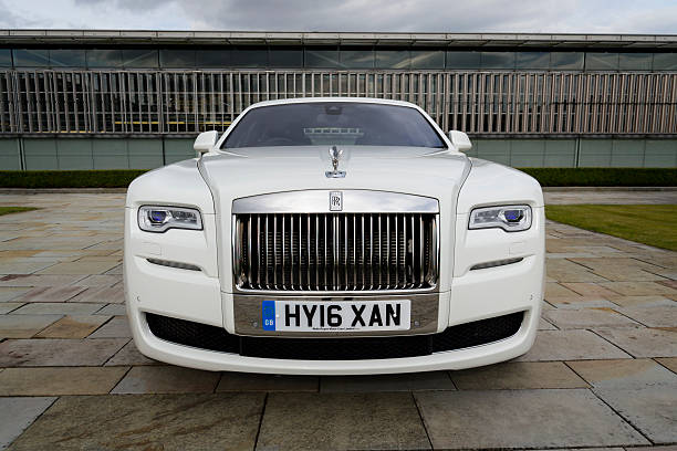 Rolls-Royce Ghost in front of the Goodwood plant Westhampnett, United Kingdom - August 11, 2016: Rolls-Royce Ghost stands in front of the Goodwood car factory. Ghost remains one of four Rolls-Royce models while company develops its first SUV. rolls royce stock pictures, royalty-free photos & images