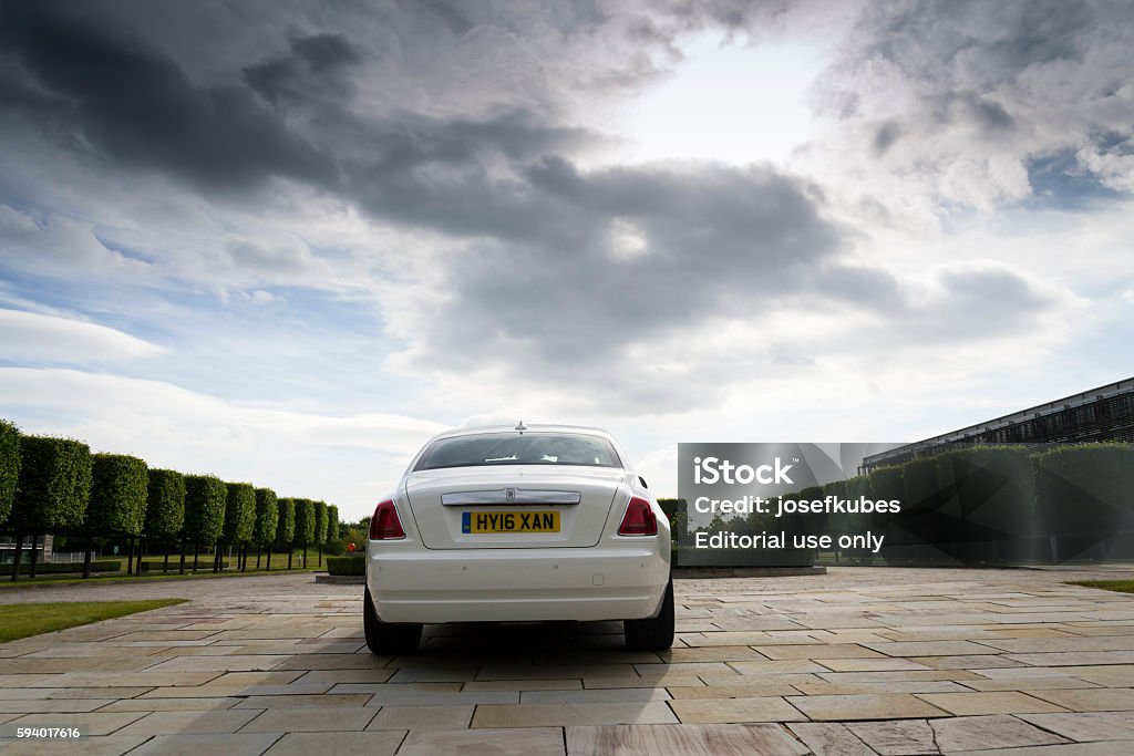 Rolls-Royce Ghost in front of the Goodwood plant Westhampnett, United Kingdom - August 11, 2016: Rolls-Royce Ghost stands in front of the Goodwood car factory. Ghost remains one of four Rolls-Royce models while company develops its first SUV. Car Stock Photo