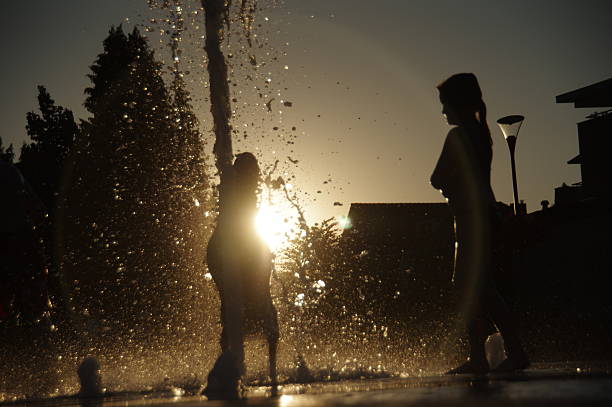istock Playing in the city fountain 594022362