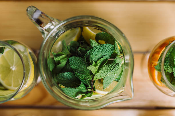 istock Cocktail with orange and mint. Pitcher, top view 594022418