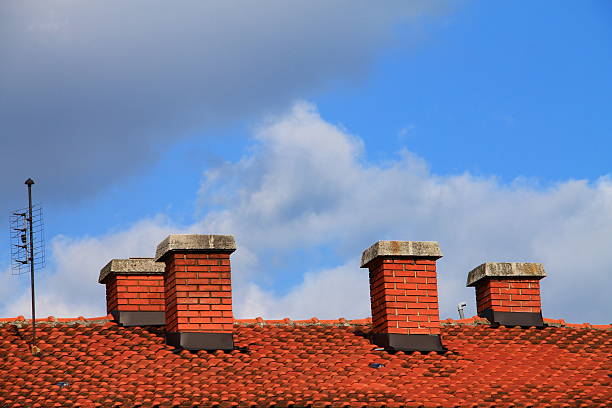 Four chimneys on the roof of the house stock photo