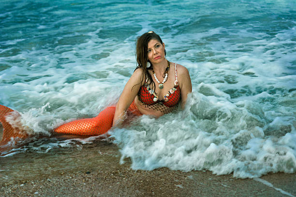istock Mermaid rests in shallow waves in Atlantic Ocean 594027726