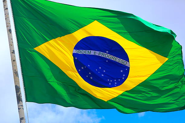 istock Ordem e Progresso: Colorful Brazillian Flag waving in the sky 594031694