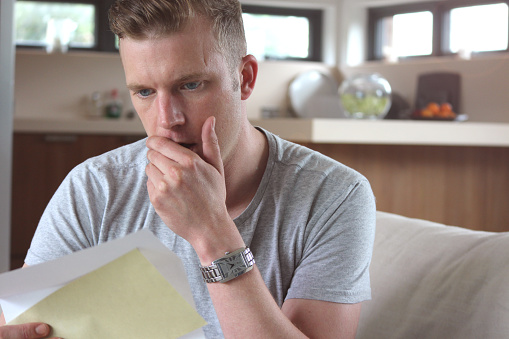 Man reading shocking letter