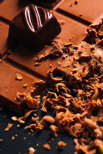istock Many candy and chocolate chips on a black background 594033216