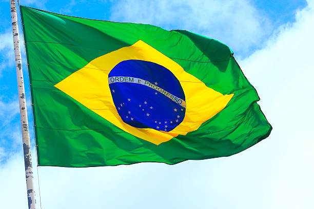 istock Ordem e Progresso: Colorful Brazillian Flag waving in the sky 594033568