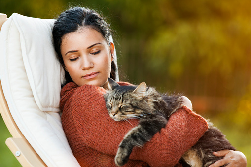 young beautiful woman sleeping outdoor with her cat