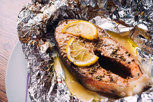 istock fish steak baked with lemon and herbs in foil 594033888