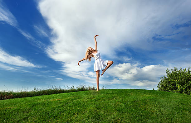 istock woman dancing in white short dres 594034924