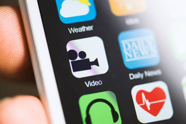 istock Hand holding smart phone, video app on screen 594035712
