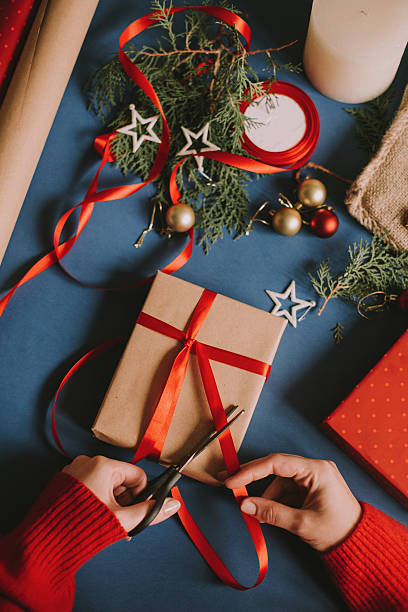 istock Cutting ribbon on Christmas present 594036868