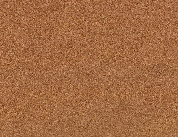 istock Rough texture of brown sandpaper. 594039064