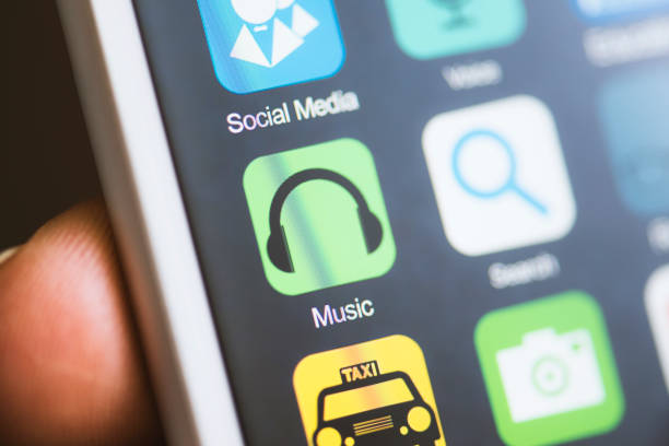 istock Hand holding phone music app on screen 594040242