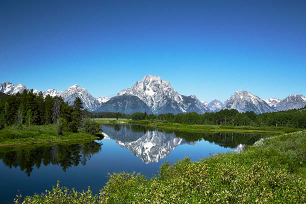 Grand Tetons from Oxbow Bend, Wyoming Grand Tetons reflected in still water of the Snake River at Oxbow Bend. teton range photos stock pictures, royalty-free photos & images