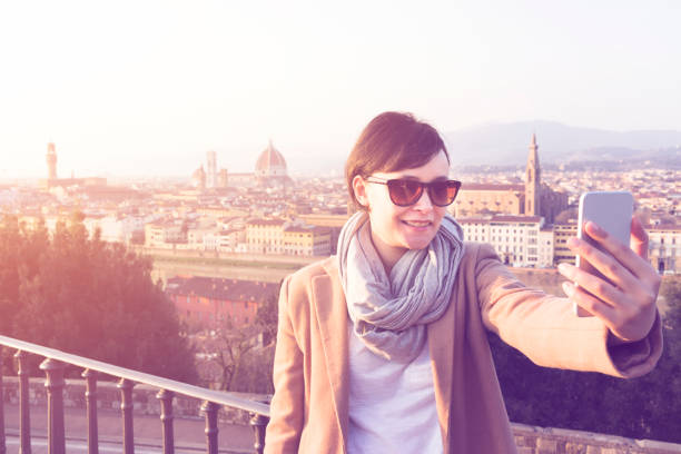 istock Young woman taking selfie outdoors, smiling 594041968