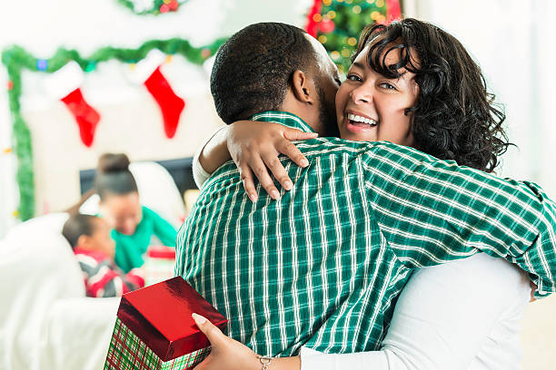 istock Beautiful mother hugs husband on Christmas day 594042444