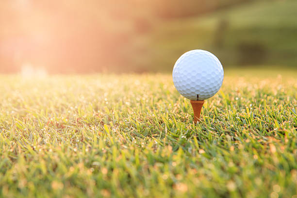 istock Golf ball on a tee against the golf course 594043588