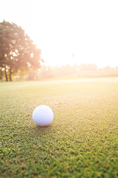 istock Golf ball on green grass in golf course 594043618