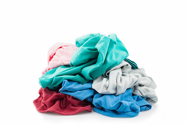 istock pile of dirty laundry Isolated on white. 594045468