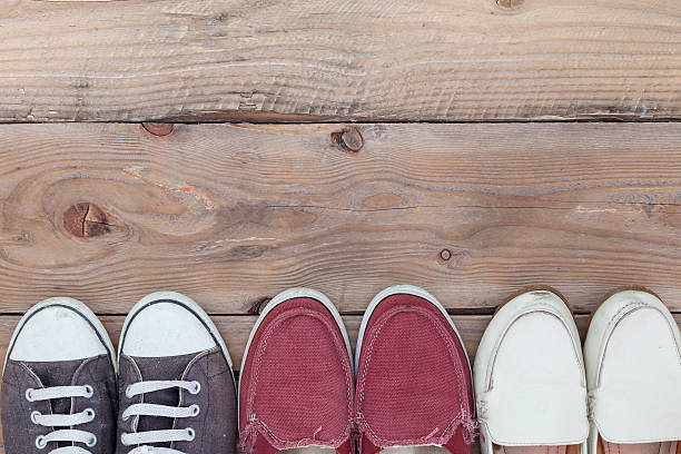 istock Dirty old shoes on wooden floor, with copy space. 594046568