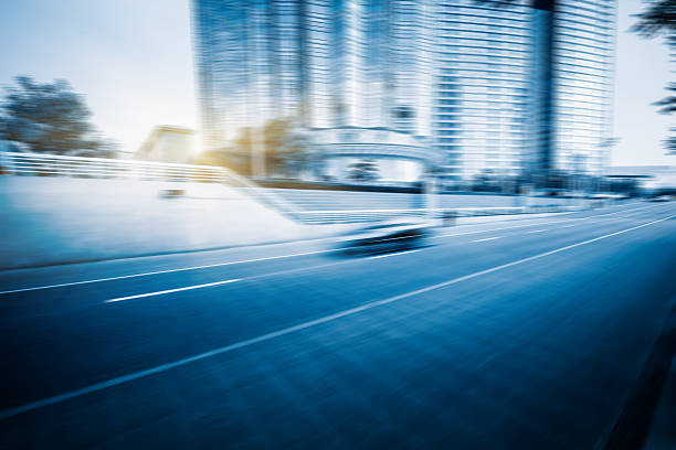 istock City road with moving traffic 594051346