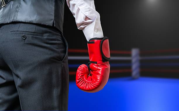 istock Hand of boxing businessman in box ring. 594051542