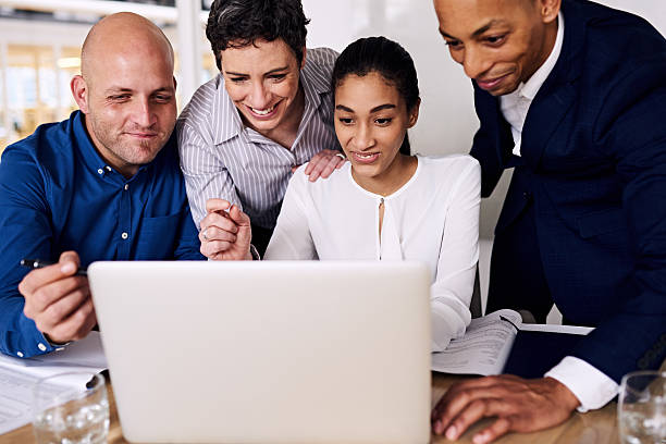 istock Four business people smiling about their executive bonuses as partners 594053340