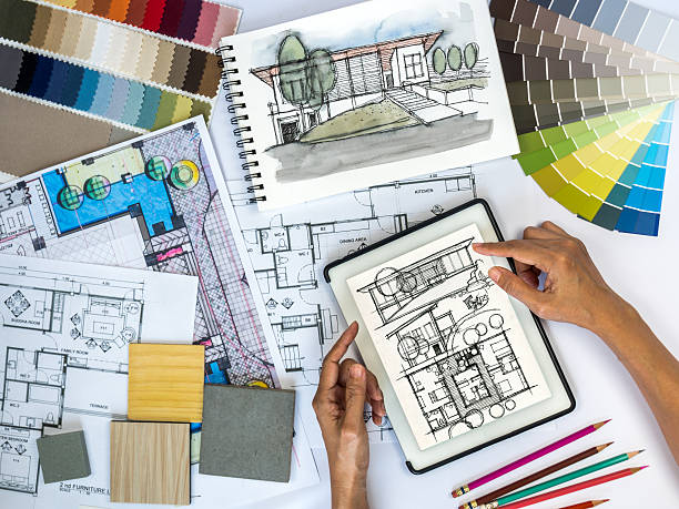 Architect, interior designer working at worktable with tablet & sketch Top view of architect & interior designer working at worktable with tablet, sketch & blue print/ Real estate business & renovation conceptual design color swatch painting plan stock pictures, royalty-free photos & images