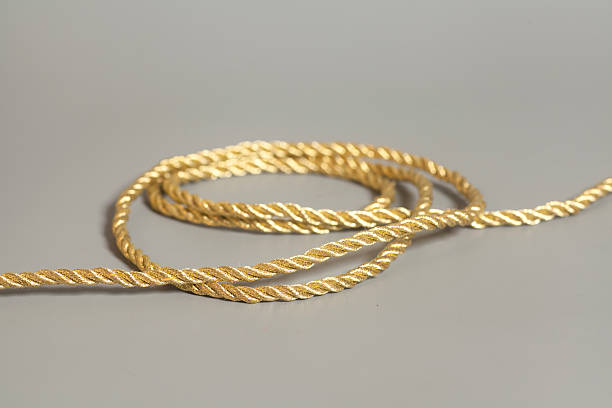 istock Golden rope  on gray background 594054602