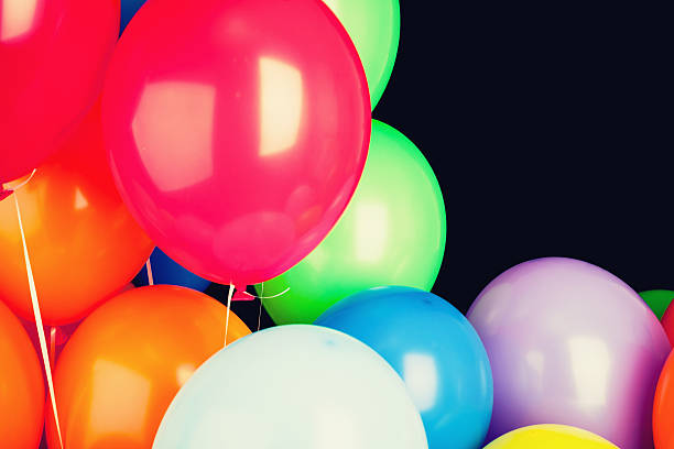 istock Group of glossy colorful balloons over black 594055484