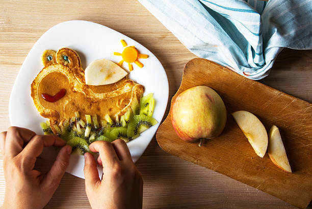 Mom prepares a funny children's breakfast
