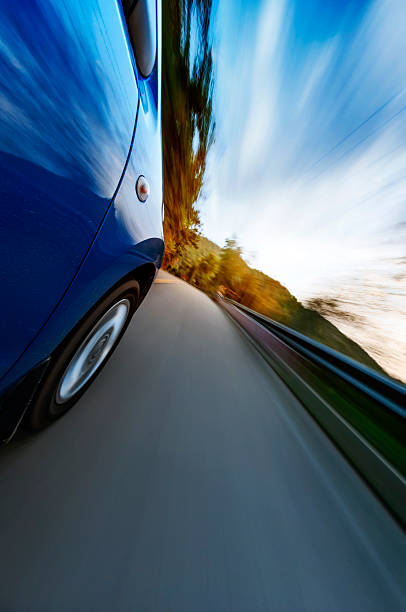 istock car driving on a motorway at high speeds 594056456