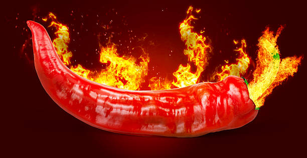 istock Red hot chili pepper on black background with flame 594057206