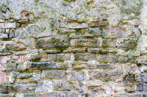 Real texture of old stone bricks with moss. Quality photo background of brickwork. Good for 3D works or wallpaper, backdrop